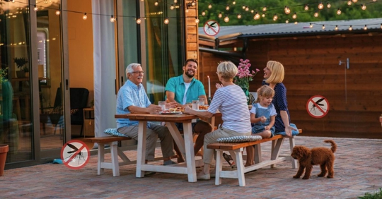 Family enjoying a meal in their backyard