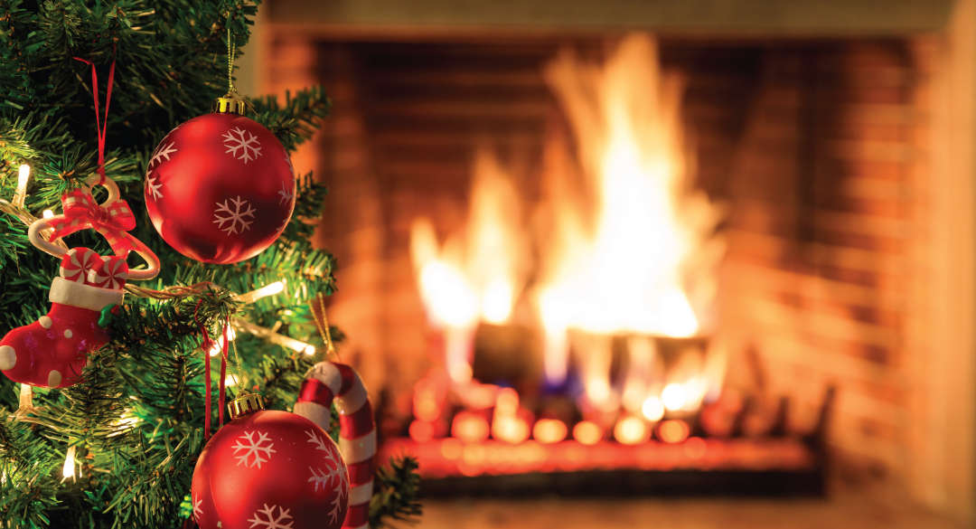 Fire safety Tip for the holiday season. Image of a Fireplace with fire burning and a Christmas tree with ornaments.