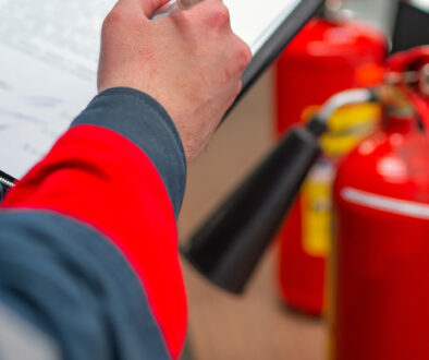 someone inspecting a fire extinguisher