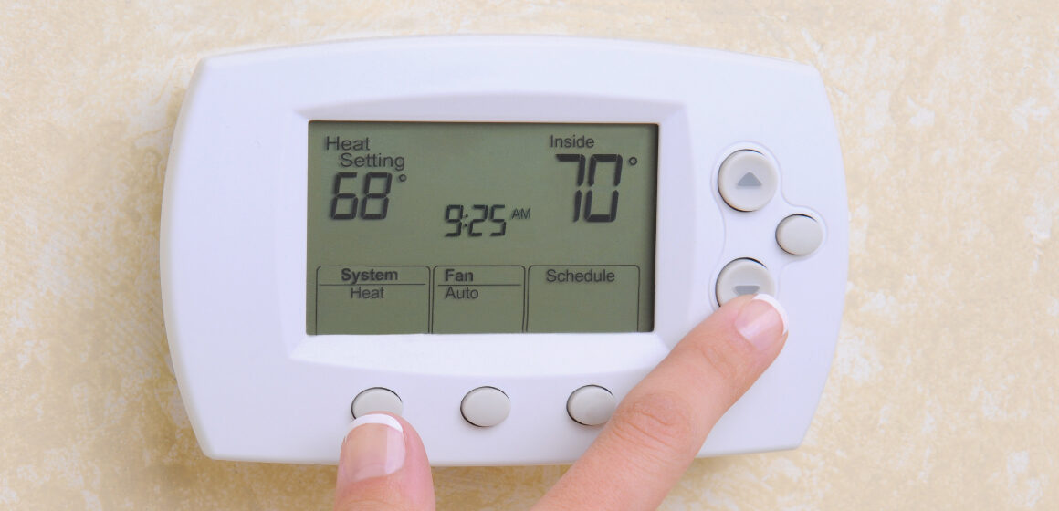 An image of a air conditioners thermostat on the wall